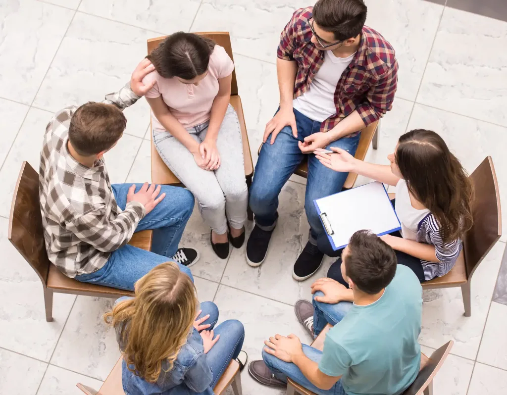 Group therapy. Group of people sitting close to each other and communicating.