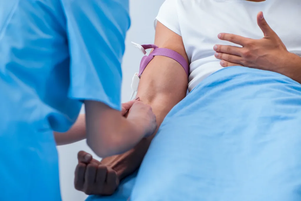 Woman doctor examining male patient in hospital